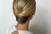 a super sleek and elegant low chignon with a sleek top is a stylish idea for a formal wedding, it will be picture-perfect