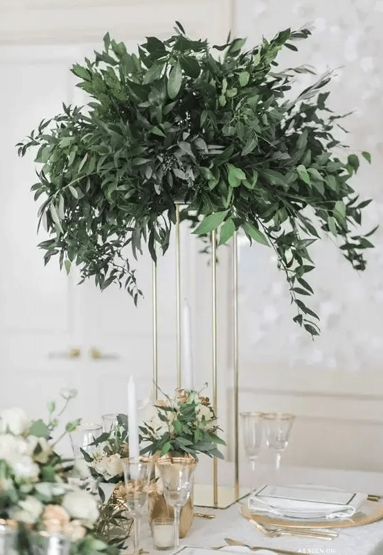 a tall eucalyptus centerpiece on a gilded frame is great for a modern wedding and to save some table space