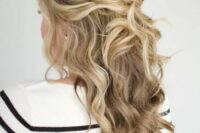 a twisted and wavy half updo with a bump on top, some curls down and face-framing hair is amazing
