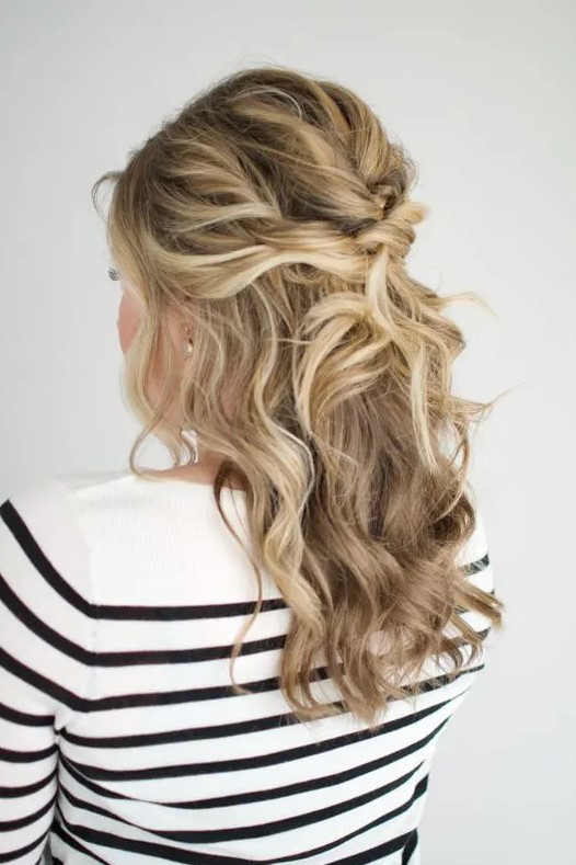 a twisted and wavy half updo with a bump on top, some curls down and face-framing hair is amazing