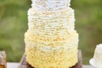 a whimsical and cute ombre ruffled wedding cake with lemons on top for a vintage-inspired wedding