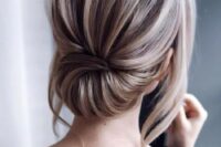an elegant low updo with a dimensional bump and locks down is a stylish modern hairstyle
