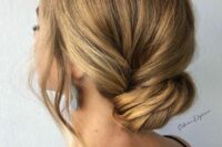 an elegant twisted low bun with hair framing the face and a bump is a chic and refined idea to rock