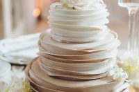 an ombre ruffle wedding cake topper with white and blush blooms is a delicate and pretty idea for a spring wedding