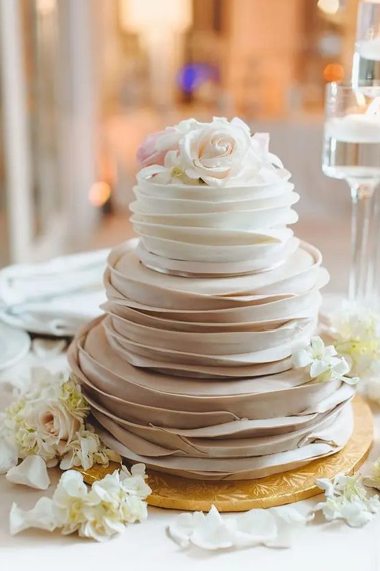 an ombre ruffle wedding cake topper with white and blush blooms is a delicate and pretty idea for a spring wedding