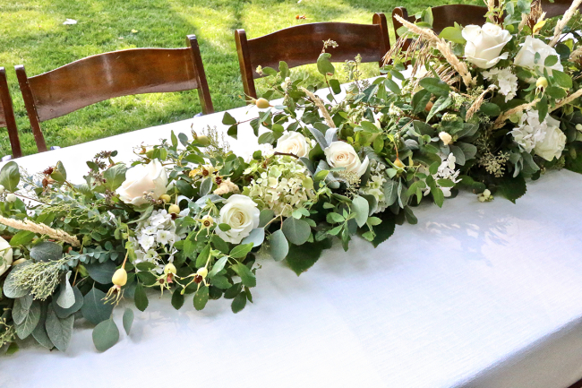 DIY greenery with white blooms and wheat table runner (via www.thefarmchicks.com)