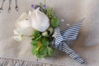 DIY floral boutonniere with berries and ribbon