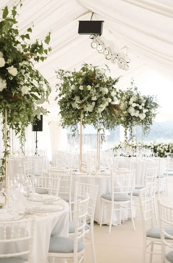 gorgeous tall greenery and white bloom centerpieces are amazing for styling a wedding reception, they look chic and beautiful and add freshness to the space