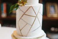 02 a white wedding cake with a crackle effect and greenery and a succulent is a simple and stylish idea