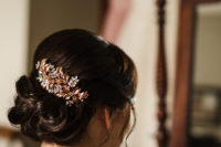 The bride was rocking an elegant wavy updo and a vintage copper hairpiece with rhinestones