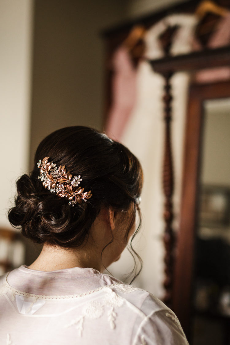 The bride was rocking an elegant wavy updo and a vintage copper hairpiece with rhinestones