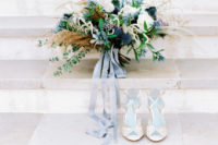 03 The bride was wearing lace shoes and was carrying a large undone wedding bouquet with plenty of texture