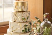 03 a chic gold and white geometric wedding cake with a crackle effect and a botanical pattern on the back