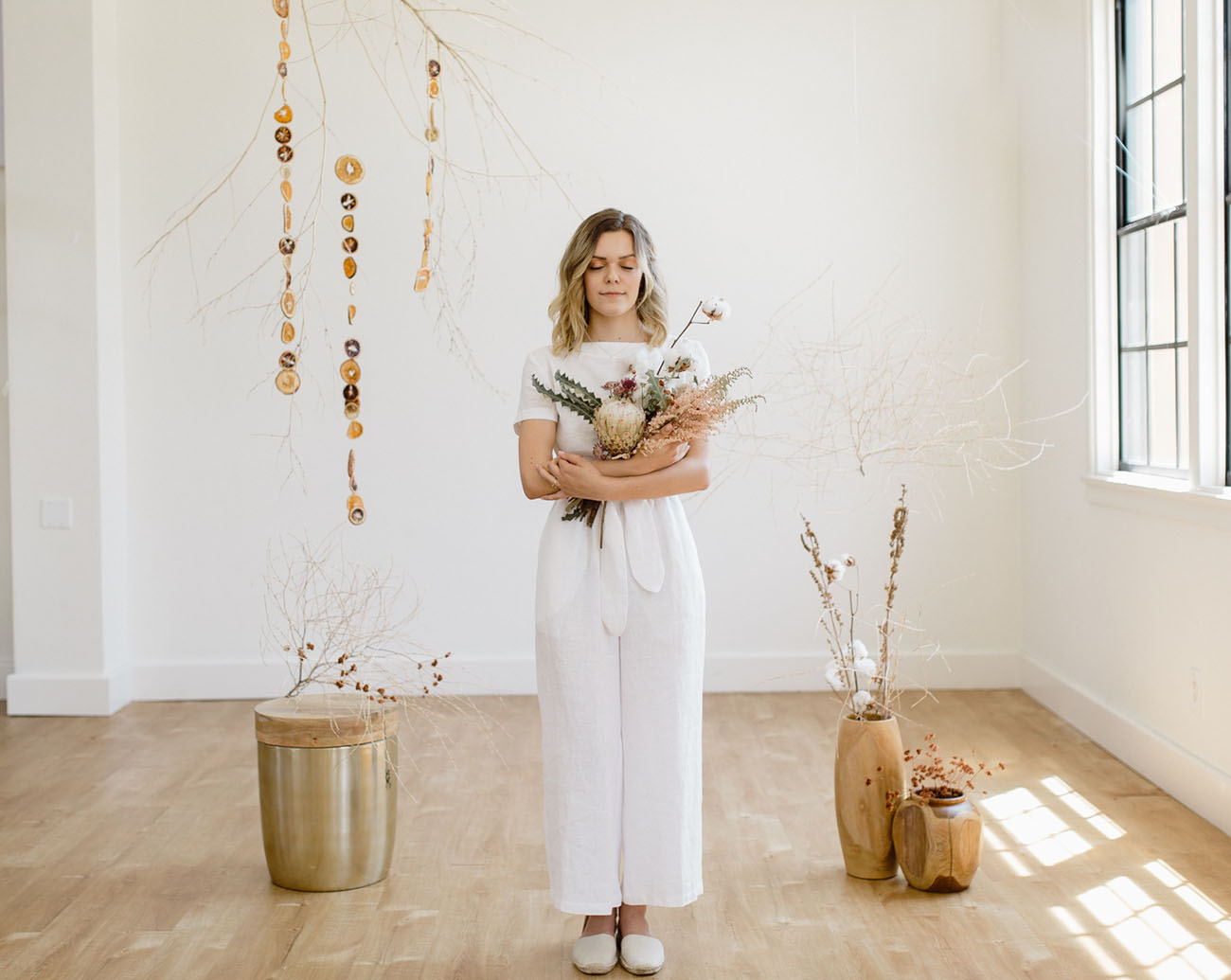 The bride was first wearing a handmade white linen suit and flats for a minimalist feel