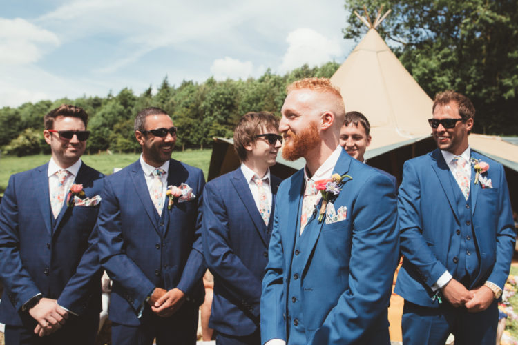 The groom and his best man were wearing three-piece blue suits and the groomsmen were wearing navy