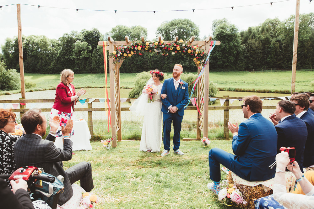 The wedding arch was done with bright florals, pink and yellow ones