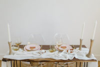 08 The sweetheart table was decorated with a fabric runner, wooden candle holdersm touches of gold and pink
