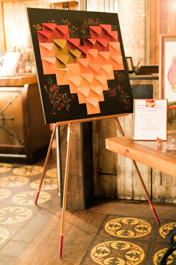 a modern and bold idea of a wedding guest book with an ombre envelope heart to fill it
