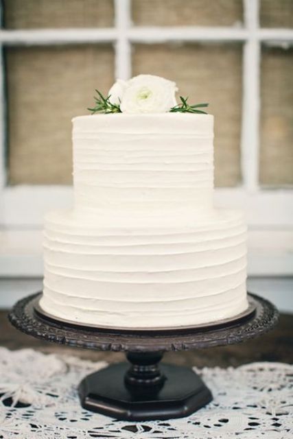 a textural white wedding cake with white blooms on top is a great idea to rock classic whites but spruce them up with a texture
