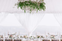 09 The wedding venue was super elegant and refined, done with lush greenery and blooms for a garden feel