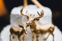 09 metallic gold deer cake topper with a large letter on top is what you need for a woodland or rustic wedding