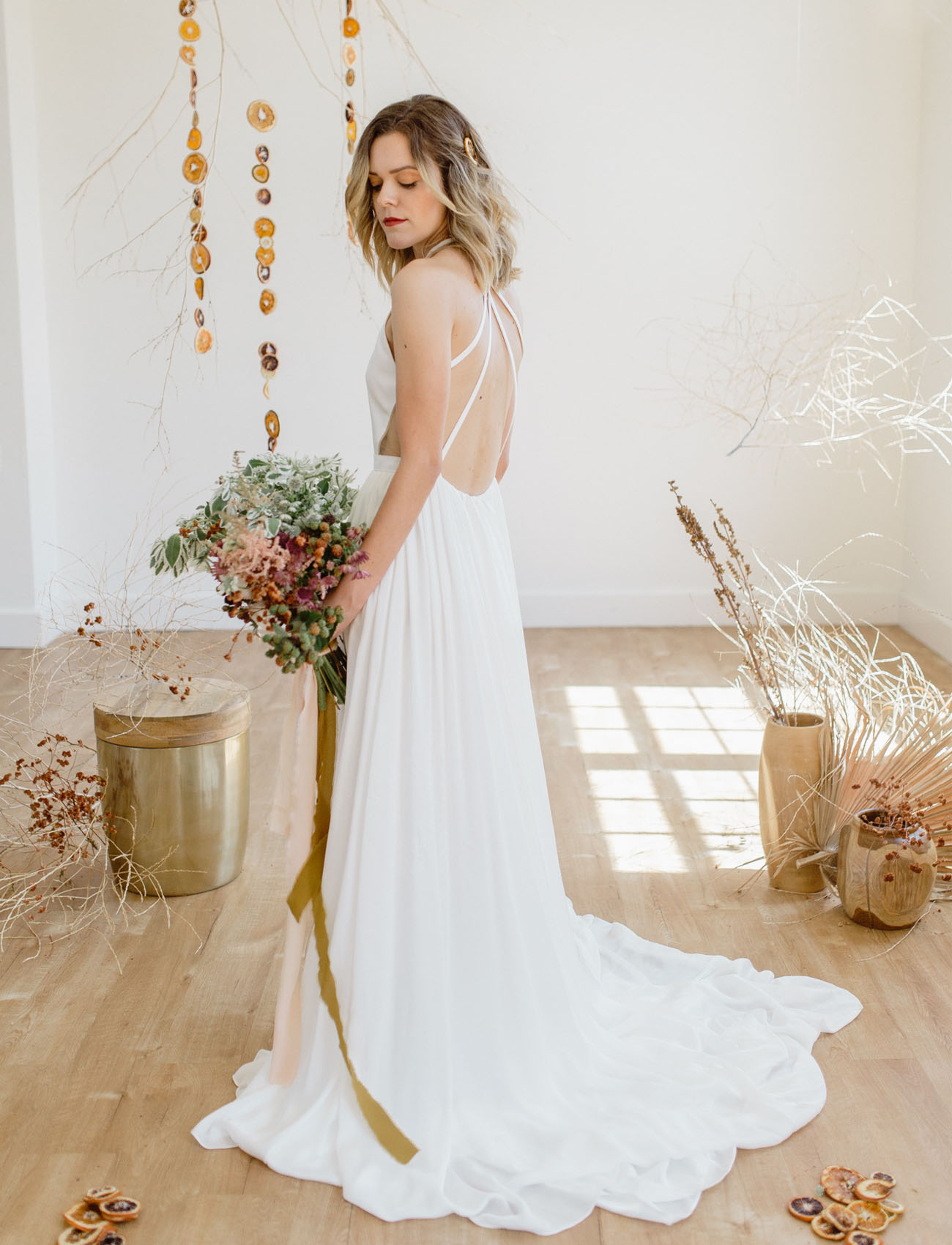 The bride switched for a minimalist wedding gown with a strappy back and a halter neckline