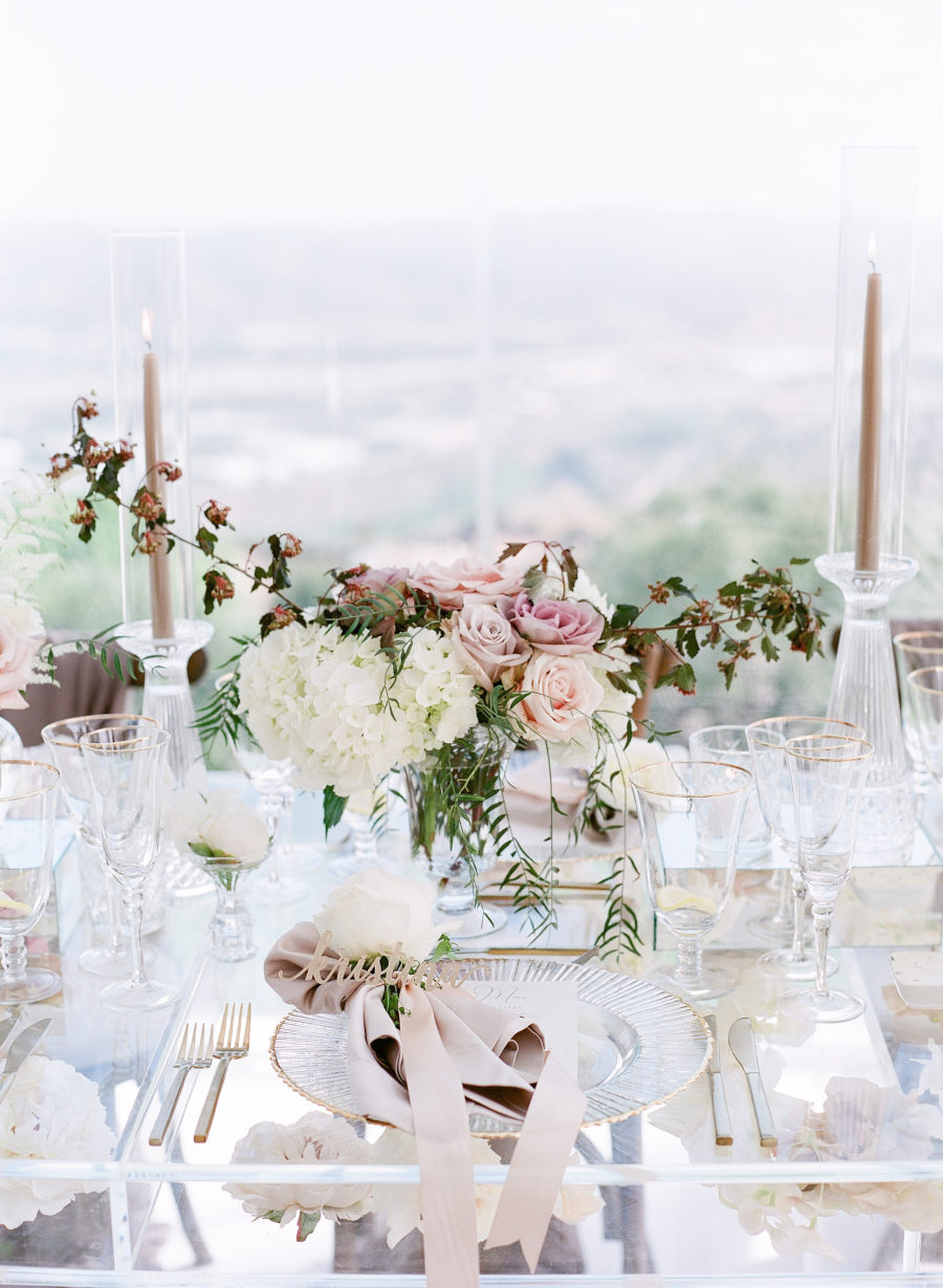 The tables were glass ones, the candles and decor was very neutral and the centerpieces were of chic pink, blush and white flowers