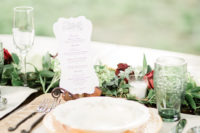 10 The wedding tablescape was done with a floral and greenery runner, elegant plates and chargers