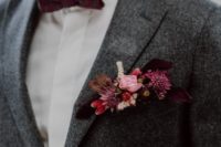 10 a grey tweed suit, a burgundy bow tie and a floral boutonniere in pink and burgundy