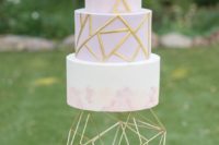 10 a lavender geometric wedding cake with gold patterns and a marbled tier plus a bold geometric cake stand