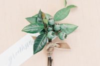 11 a foliage boutonniere with berries is a chic and catchy idea that doesn’t include any blooms