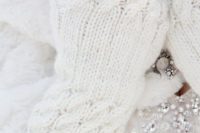11 gorgeous white cable knit fingerless mittens decorated with heirloom brooches are a refiend accessory