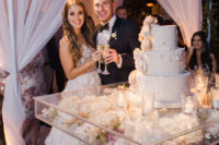 12 The wedding cake was a giant one with sugar flowers and it was presented on a clear glass stand filled with blooms