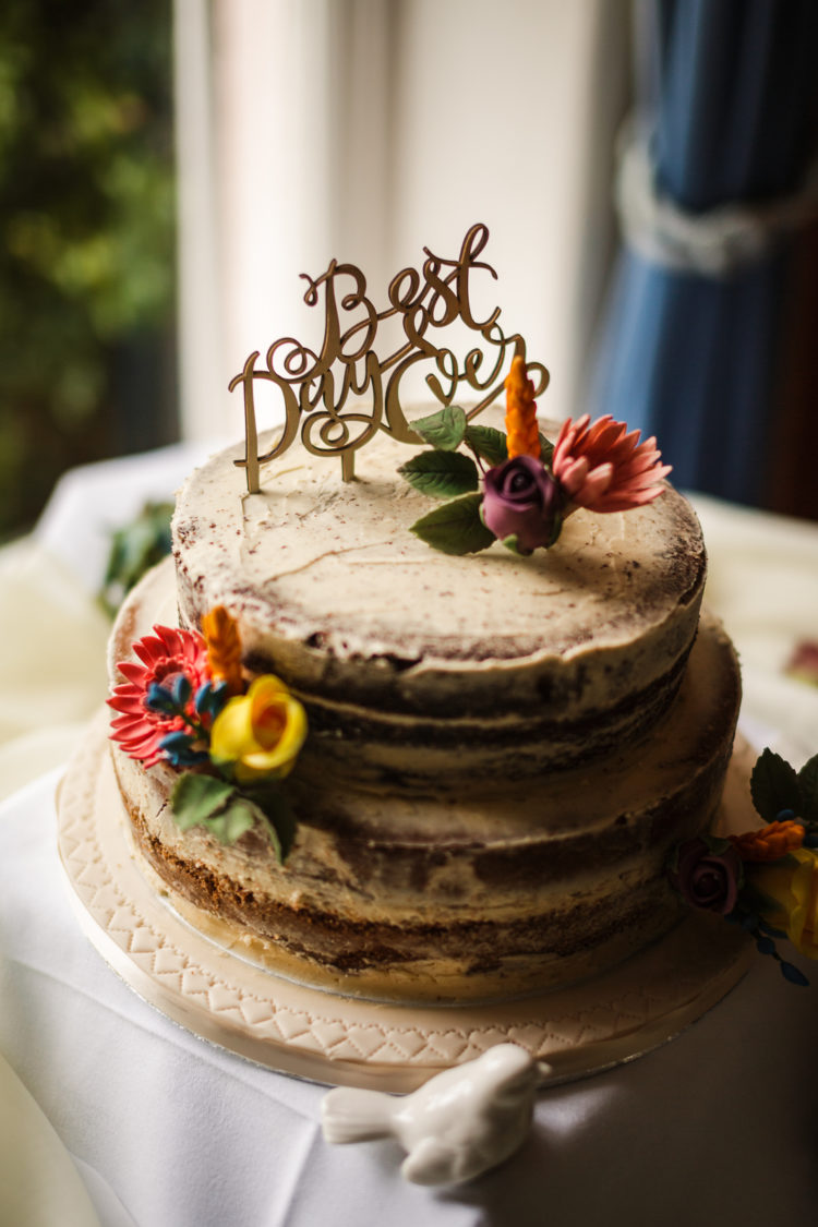 The wedding cake was a semi naked one, topped with a calligraphy topped and blooms
