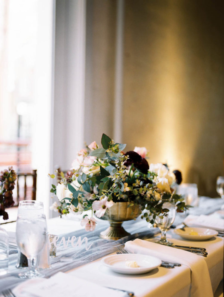 The wedding tablescapes were done with airy runners and lush yet nonchalant florals