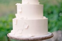 12 a gorgeous white wedding cake with white sugar flowers and petals falling down for a wow effect