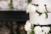 14 a trio of minimalist plain wedding cakes served with white peonies is an elegant modern wedding idea