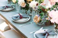 15 a grey and burgundy table setting is spruced up with lush florals of various muted shades