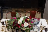 16 a gorgeous tablescape with an industrial feel, grey plates and chargrers and burgundy napkins and blooms for a chic look