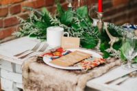 17 a greenery garland, red candles and fur place setting are amazing for a winter or a holiday wedding
