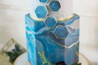19 a blue marble and concrete-inspired wedding cake and marbleized hexagons with a gold edge