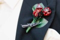 creative red boutonniere for a daring groom