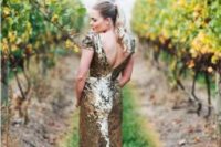 19 a gold sequin wedding dress with a cutout back, cap sleeves and a small train will make you stand out