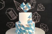21 a colorful geometric wedding cake with a blue geometric heart topper is a modern and romantic option