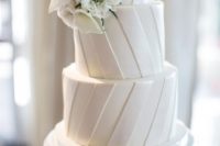 21 a striped white wedding cake topped with white blooms is a cool and timeless idea to rock