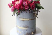 25 a semi naked greyish wedding cake topped with fuchsia and burgundy blooms, berries and a calligraphy topper