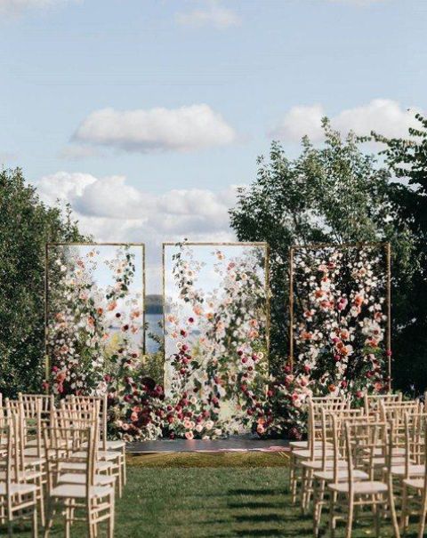 framed acrylic screens decorated with colorful blooms and greenery for a bright and luxurious wedding backdrop