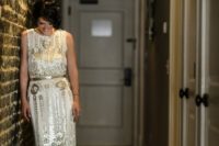 26 a sparkly white and gold embellishments art-deco wedding dress with a gold sash for a bright look