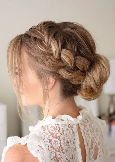 a French braid low bun with some locks down looks voluminous and very romantic