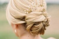 a beautiful low bun with a volume on top and a pearl headpiece is a lovely and stylish hairstyle to rock